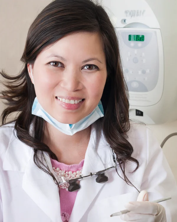 Dr. Tina Le of Tina Le DDS wearing a white coat